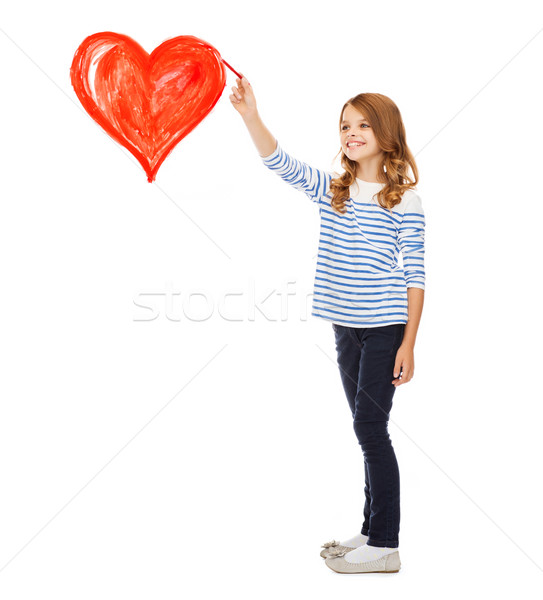 Stock photo: girl drawing big red heart in the air