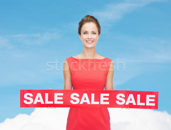 Stock photo: smiling young woman in dress with red sale sign