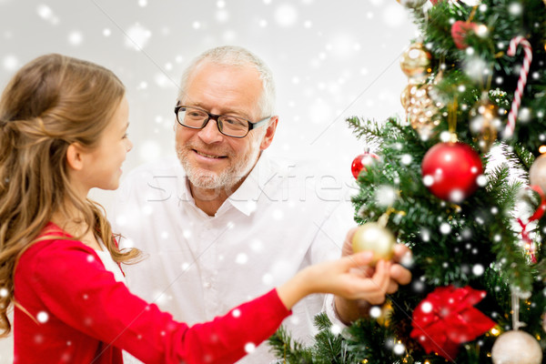 smiling family decorating christmas tree at home Stock photo © dolgachov