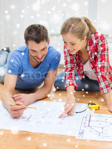 smiling couple with blueprint at home Stock photo © dolgachov