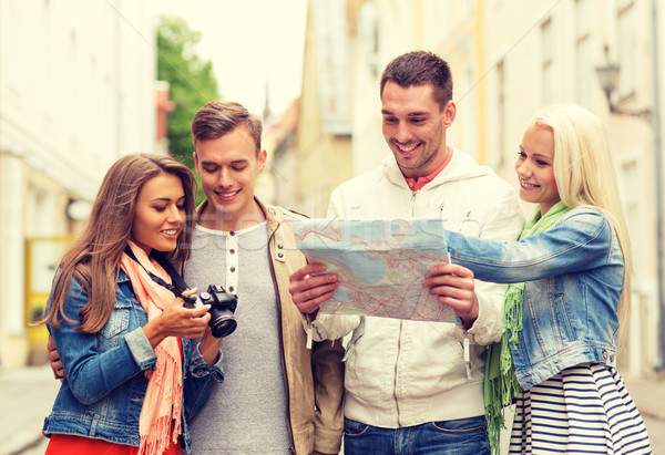 Stock photo: group of smiling friends with map and photocamera