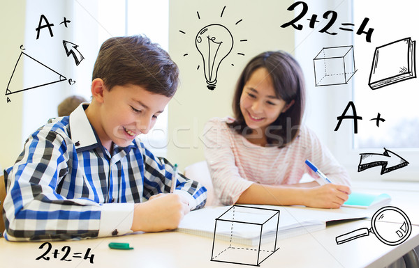 group of school kids writing test in classroom Stock photo © dolgachov