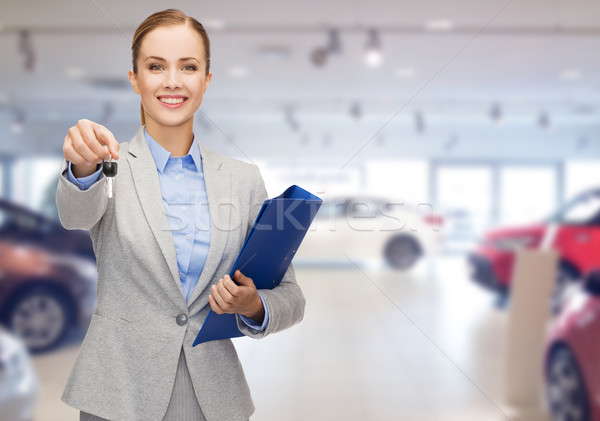 businesswoman or saleswoman giving car key Stock photo © dolgachov
