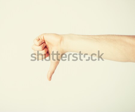 man showing thumbs down Stock photo © dolgachov