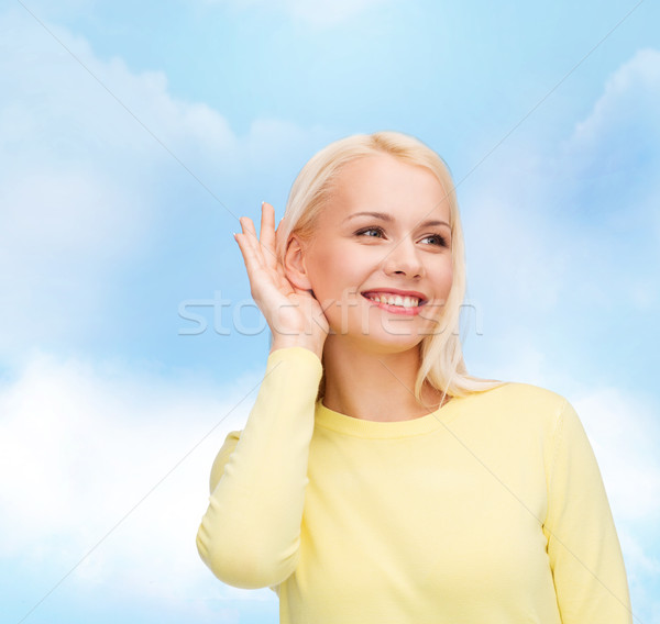smiling young woman listening to gossip Stock photo © dolgachov