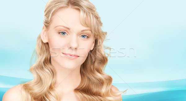 beautiful young woman face with long wavy hair Stock photo © dolgachov