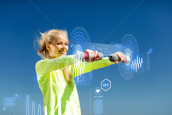 sporty woman with light dumbbells outdoors Stock photo © dolgachov