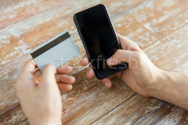 close up of hands with smart phone and credit card Stock photo © dolgachov