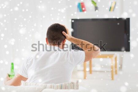 man watching tv and supporting team at home Stock photo © dolgachov