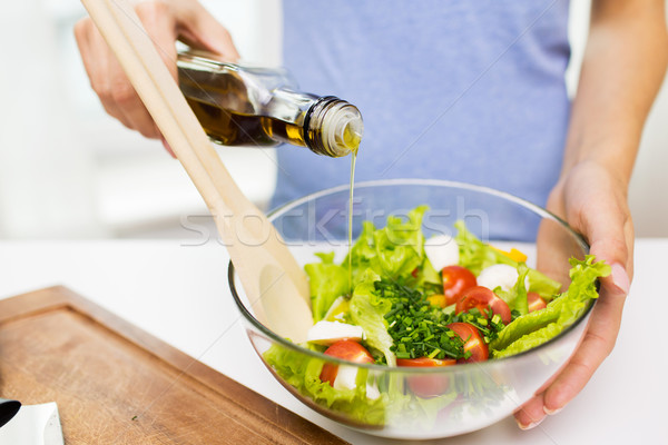 close up of woman cooking vegetable salad at home Stock photo © dolgachov