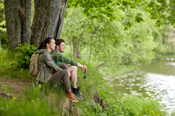 smiling couple with backpacks in nature Stock photo © dolgachov