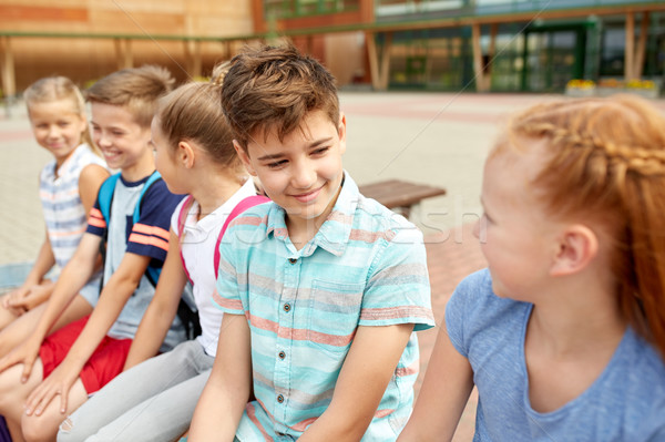 Groupe heureux école élémentaire élèves parler primaire [[stock_photo]] © dolgachov