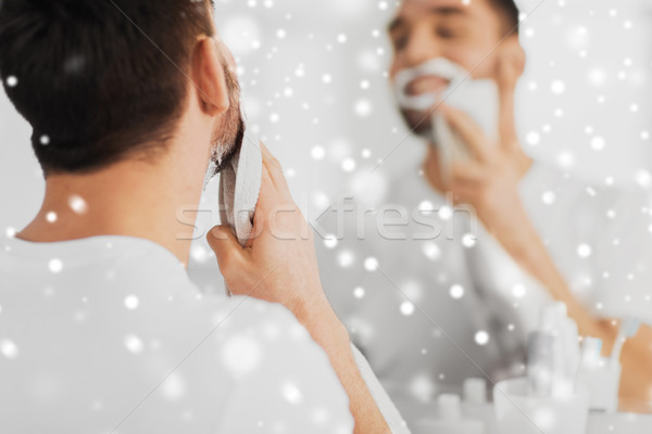 close up of man removing shaving foam from face Stock photo © dolgachov