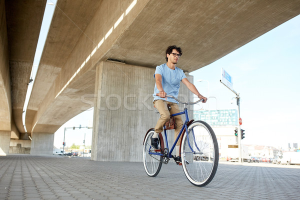 young hipster man riding fixed gear bike Stock photo © dolgachov
