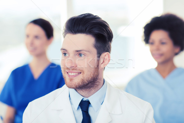 Stock photo: happy doctor over group of medics at hospital