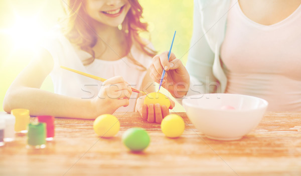 close up of family coloring easter eggs Stock photo © dolgachov