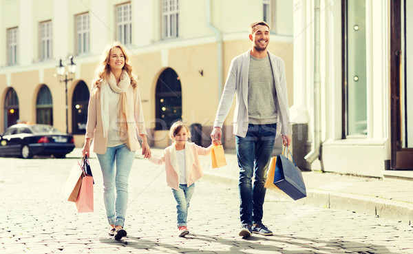 happy family with child and shopping bags in city Stock photo © dolgachov
