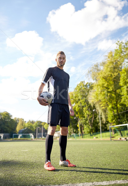 soccer player with ball on football field Stock photo © dolgachov