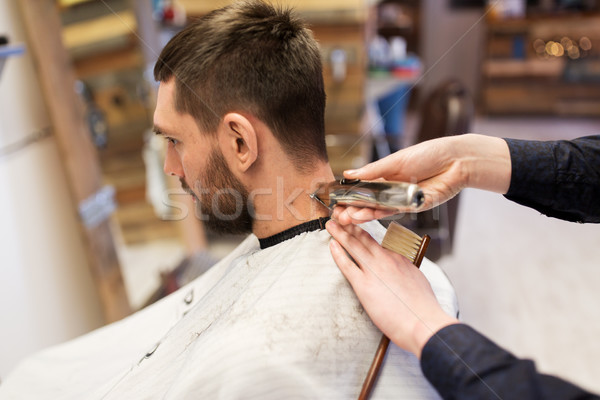 man and barber hands with trimmer cutting hair Stock photo © dolgachov