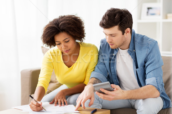 couple with papers and calculator at home Stock photo © dolgachov