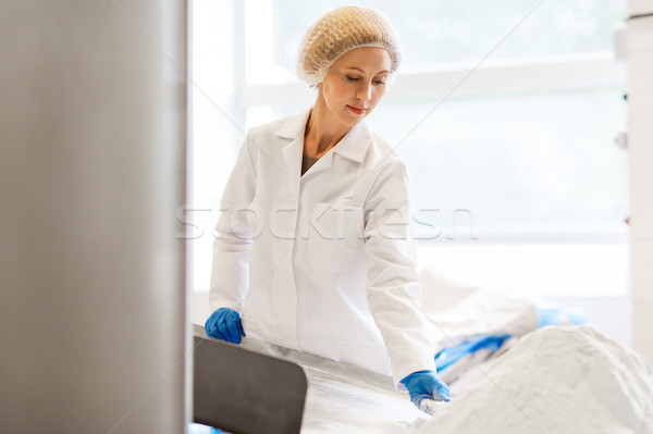 woman working at ice cream factory conveyor Stock photo © dolgachov