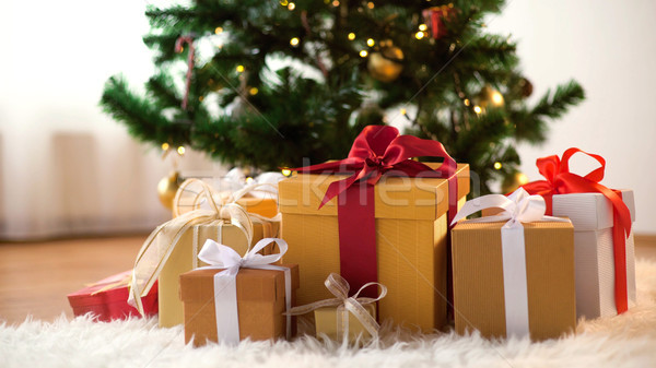 gift boxes on sheepskin at christmas tree Stock photo © dolgachov