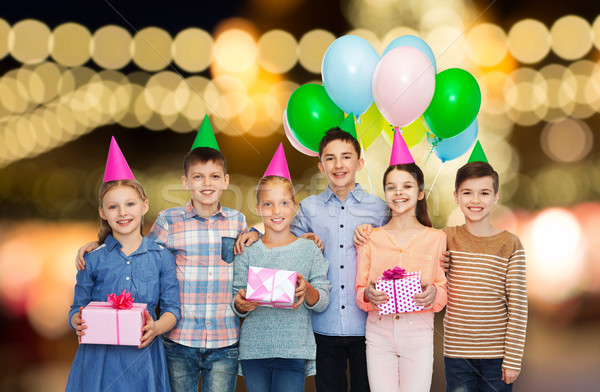 happy children with gifts at birthday party Stock photo © dolgachov