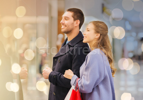 happy young couple with shopping bags in mall Stock photo © dolgachov