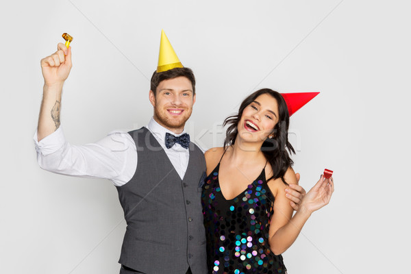 happy couple with party blowers having fun Stock photo © dolgachov