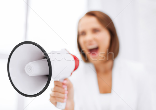 strict businesswoman shouting in megaphone Stock photo © dolgachov