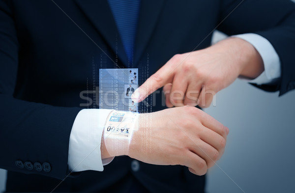 businessman pointing to something at his hand Stock photo © dolgachov