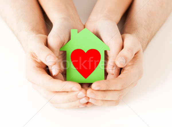 couple hands holding green paper house Stock photo © dolgachov