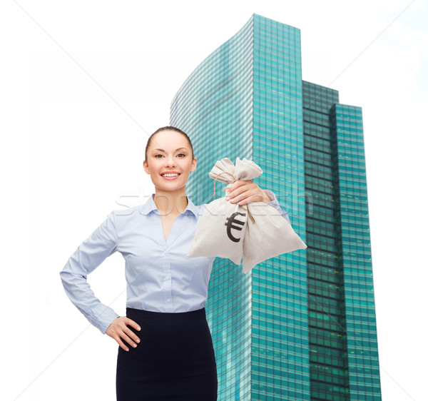 young businesswoman holding money bags with euro Stock photo © dolgachov