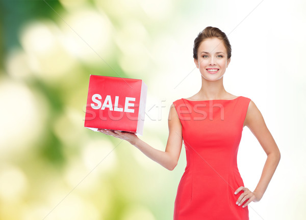 Stockfoto: Glimlachend · jonge · vrouw · jurk · Rood · verkoop · teken