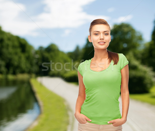Souriant jeune femme vert tshirt design loisirs [[stock_photo]] © dolgachov