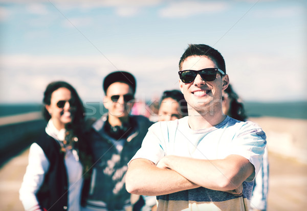 teenager in shades outside with friends Stock photo © dolgachov