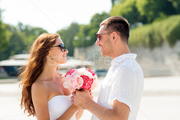 smiling couple in city Stock photo © dolgachov