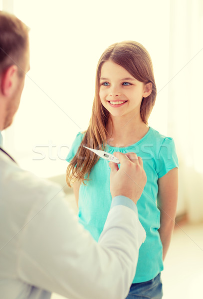 Stock photo: male doctor with child measuring temperature