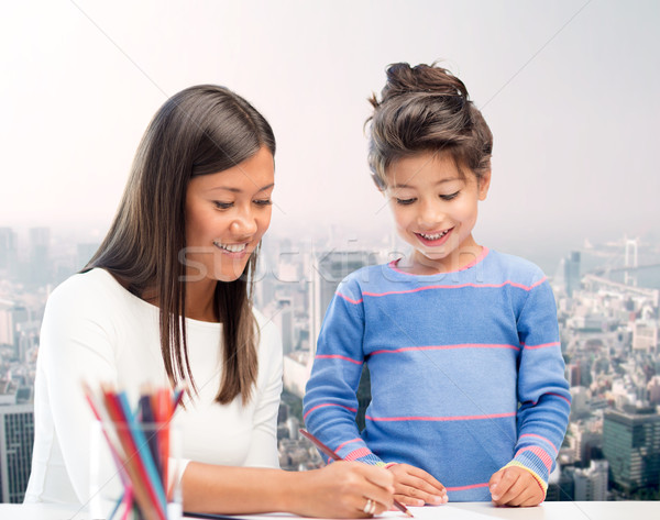 happy mother and daughter drawing with pencils Stock photo © dolgachov