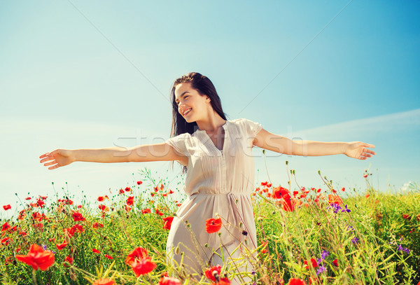 Sorridente mulher jovem papoula campo felicidade natureza Foto stock © dolgachov