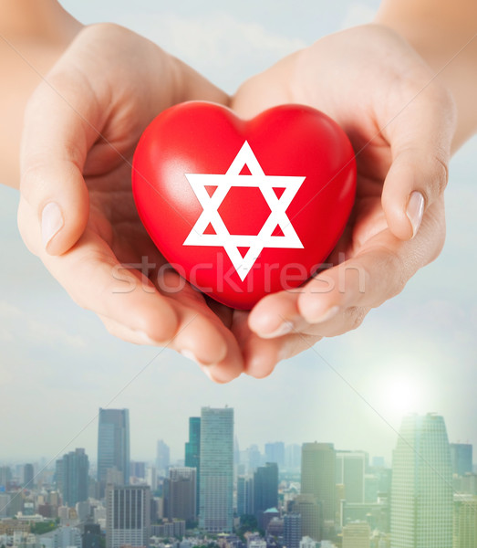 close up of hands holding heart with jewish star Stock photo © dolgachov