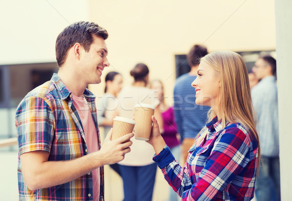 group of smiling students with paper coffee cups Stock photo © dolgachov