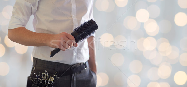 close up of male stylist with brush at salon Stock photo © dolgachov