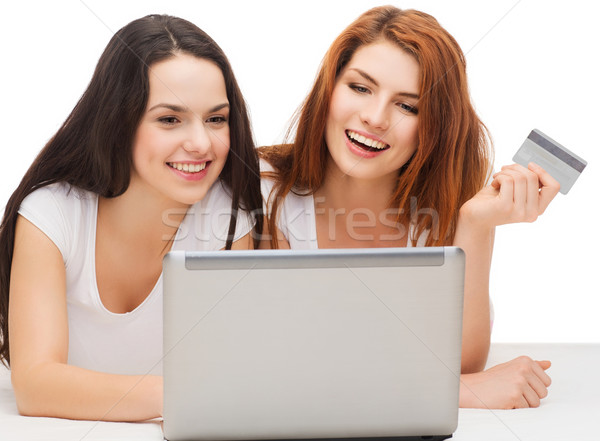 Stock photo: two smiling teenagers with laptop and credit card