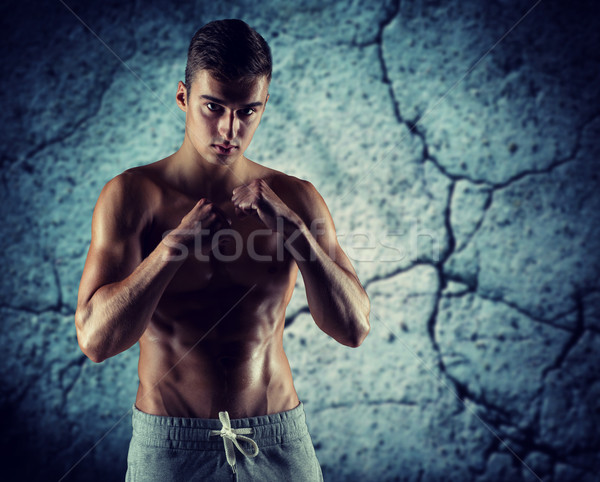 Stock photo: young man in fighting or boxing position