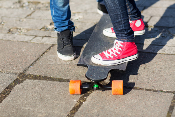 close up of couple with longboard on street Stock photo © dolgachov