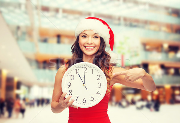 smiling woman in santa helper hat with clock Stock photo © dolgachov