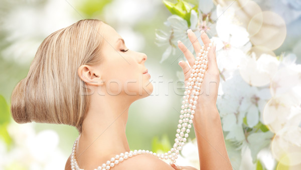 woman with pearl necklace over cherry blossom Stock photo © dolgachov