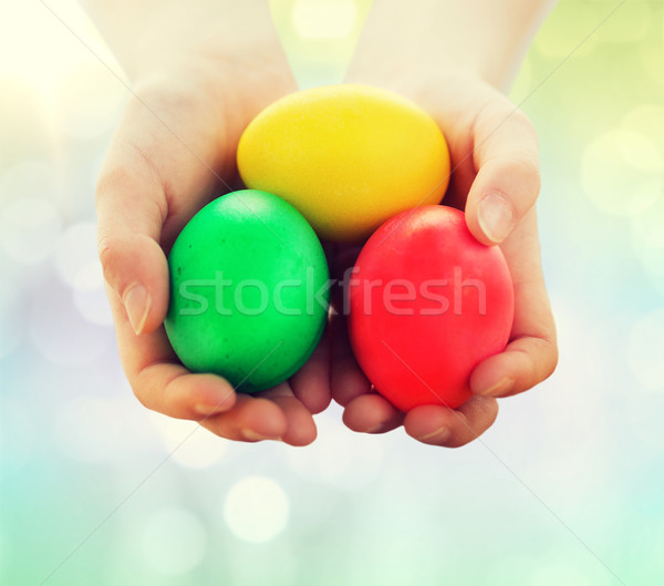 close up of kid hands holding colored eggs Stock photo © dolgachov