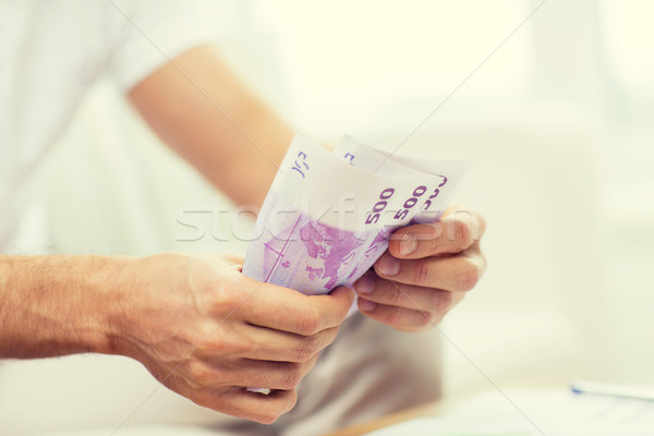 close up of man hands counting money at home Stock photo © dolgachov